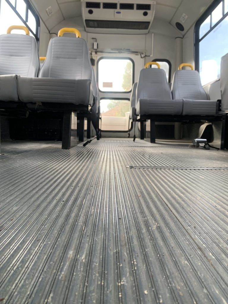 Interior view of empty school bus seats.