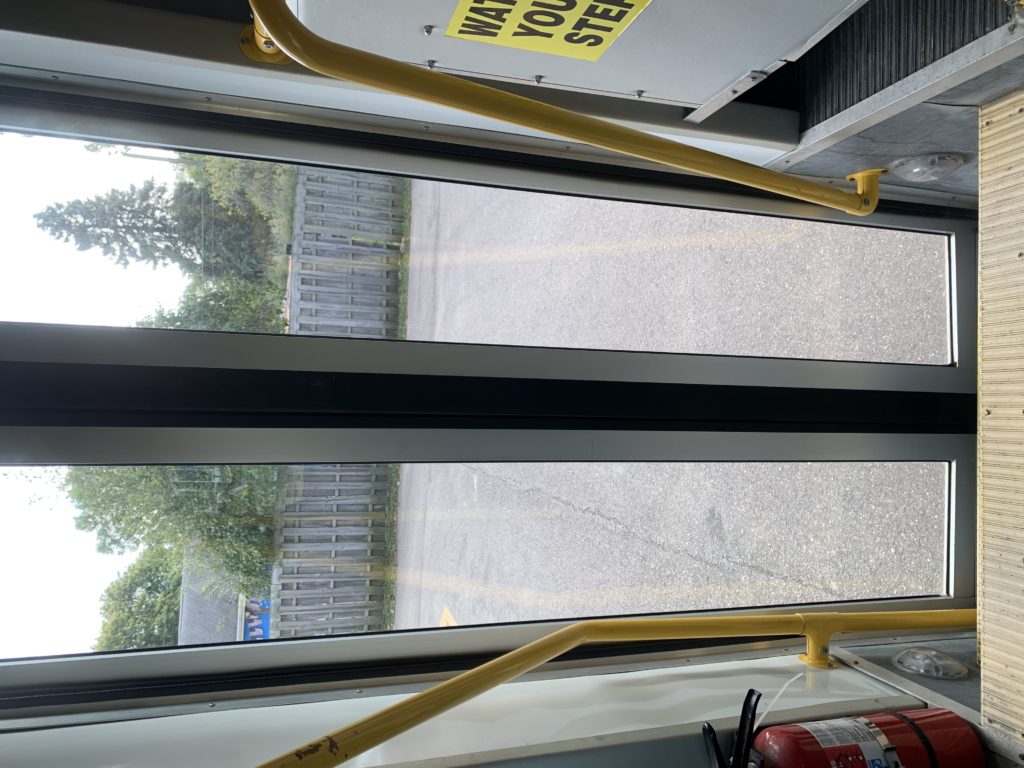 View from bus door exit onto parking lot.