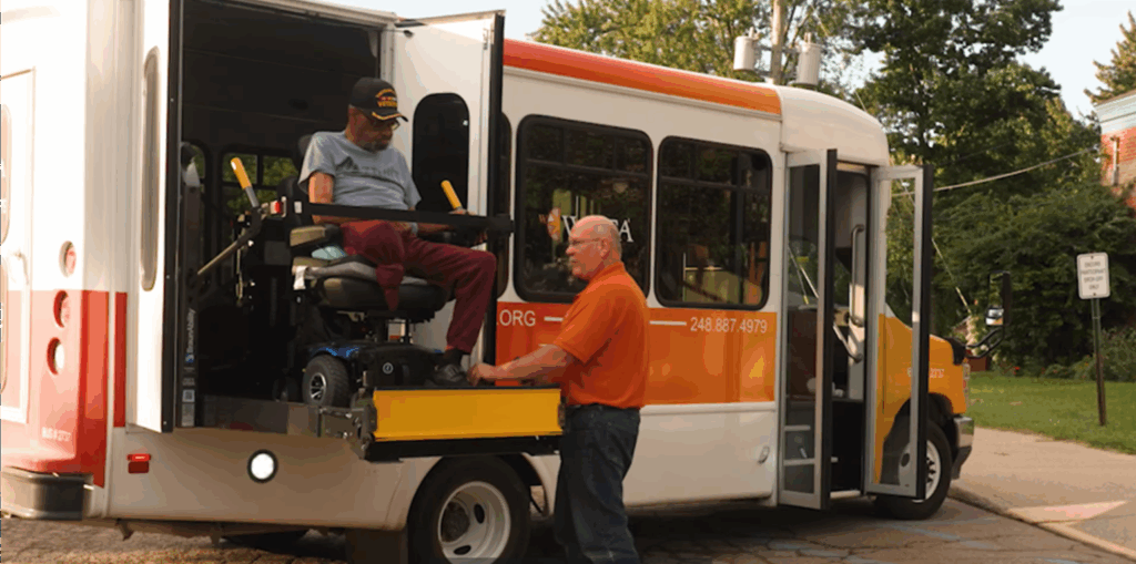 Man in wheelchair using accessible vehicle lift